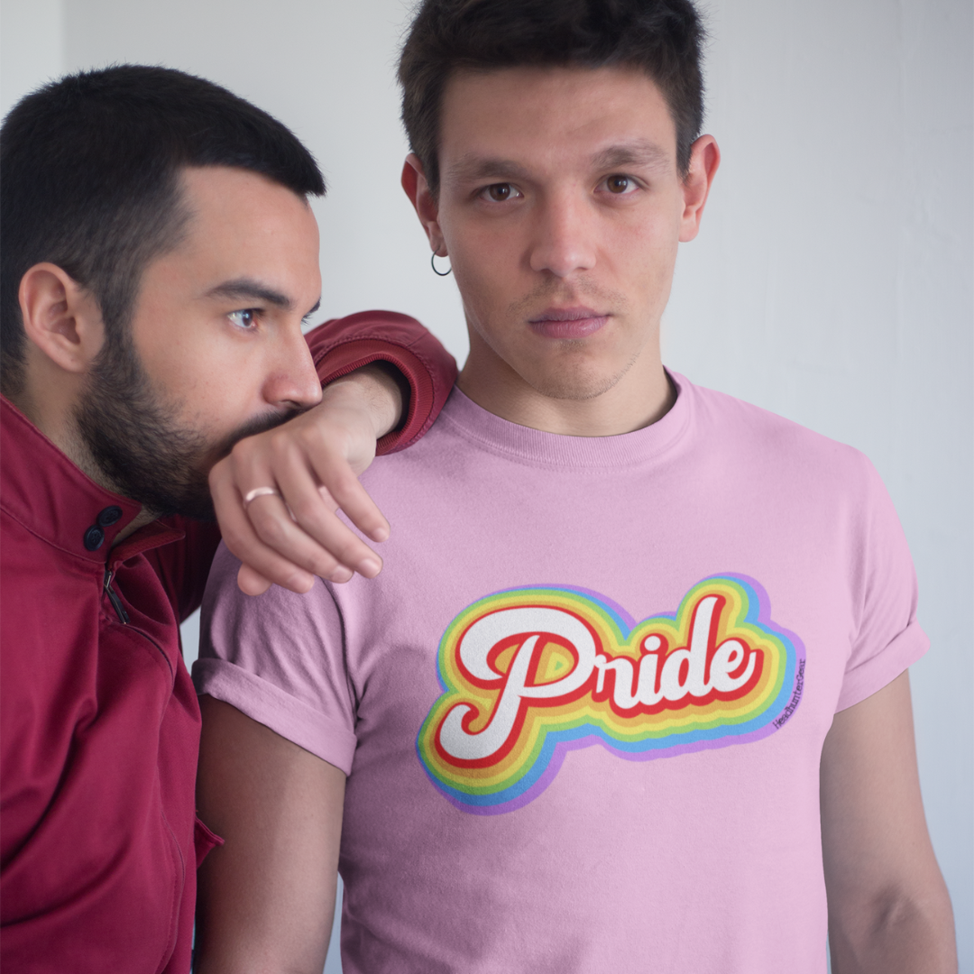 An individual confidently wears the Pride T-Shirt from HeadhunterGear, featuring retro-inspired lettering. The vibrant colors and classic design celebrate a sense of individuality and self-expression. This person stands proud, embodying the spirit of inclusivity and embracing their unique identity through fashion