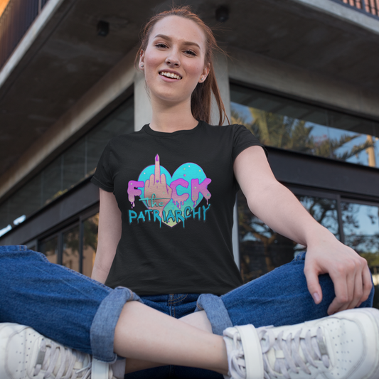 Woman wearing a black HeadhunterGear t-shirt it has a female empowerment message, Fuck the Patriarchy, and a woman's hand with the middle finger up. 